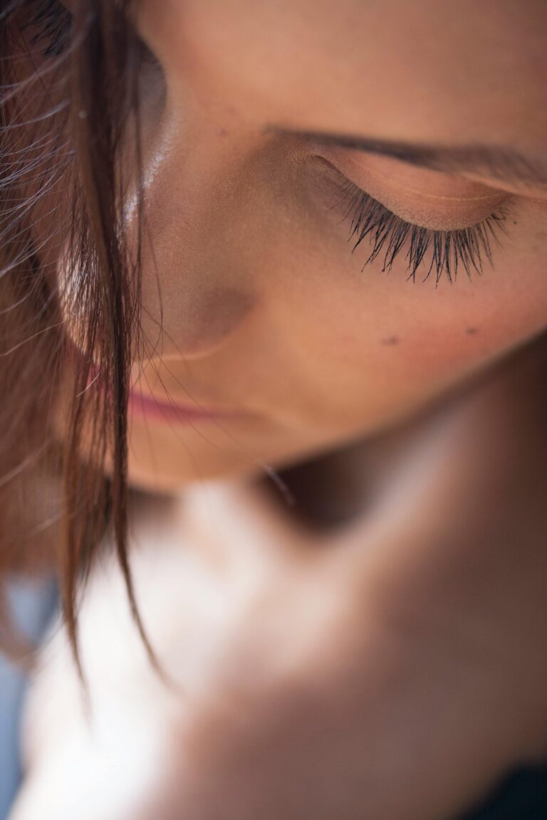 Close-up artistic portrait capturing a young woman's serene expression and natural beauty.